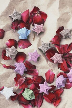 Rose petals with paper starsの写真素材