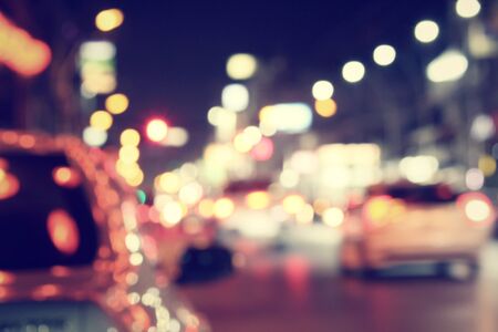 Blurred of car in city at nightの写真素材