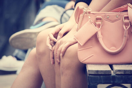 Woman sitting with handbagの写真素材