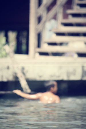 Blurred of children playing at damnoen saduak floating market, Thailandの写真素材