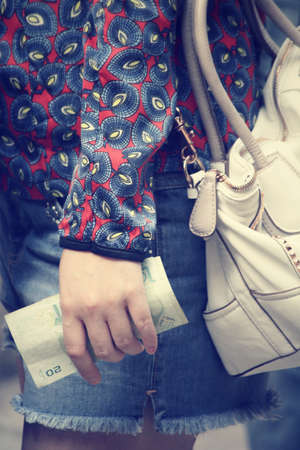 Woman holding moneyの写真素材