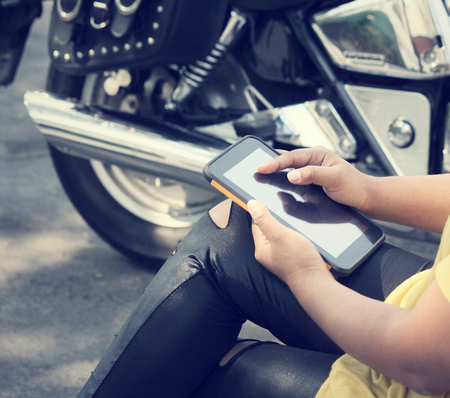 Using tablet with motorcycleの写真素材
