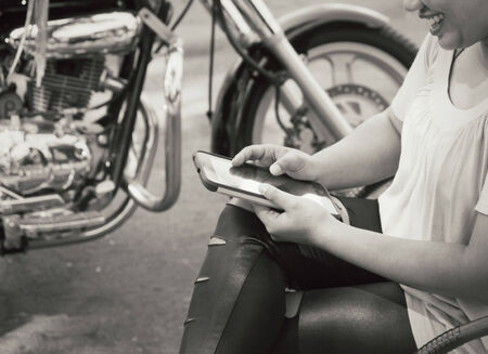 Using tablet with motorcycleの写真素材