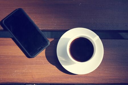 Hot coffee with smart phoneの写真素材