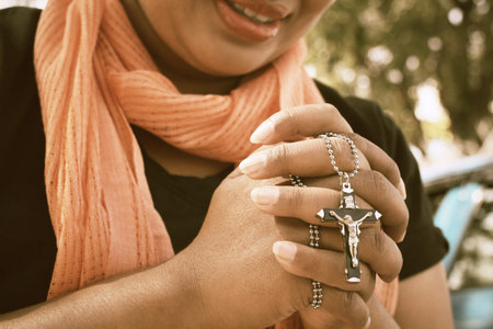 Woman hands praying with crossの写真素材
