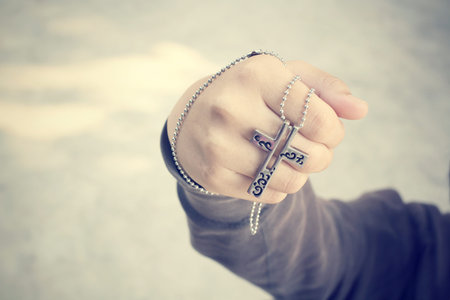 Hands praying with crossの写真素材