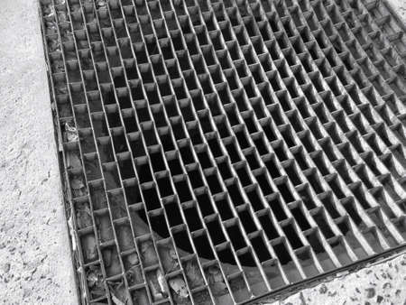 Iron drain on the roadの写真素材