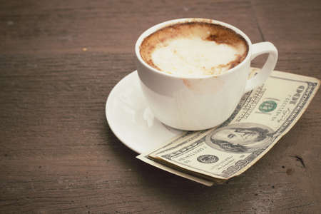 Hot coffee with dollarsの写真素材