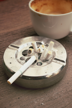 Cigarette with ashtray and hot coffeeの写真素材