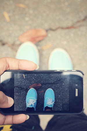 Selfie of shoes with smartphoneの写真素材