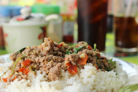 Rice topped with fried pork and basilの写真素材
