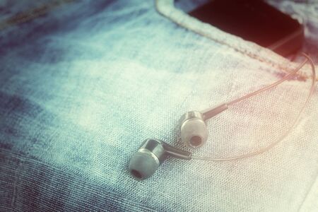 Earphone and smartphone with jeansの写真素材