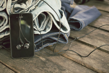 Earphone and smartphone with jeansの写真素材