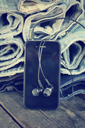 Earphone and smartphone with jeansの写真素材
