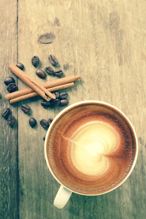 Vintage latte art coffee with cinnamonの写真素材