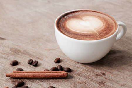 Vintage latte art coffee with cinnamonの写真素材