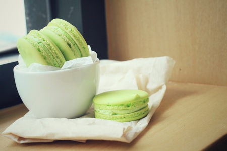 Green macaroons with coffee cupの写真素材
