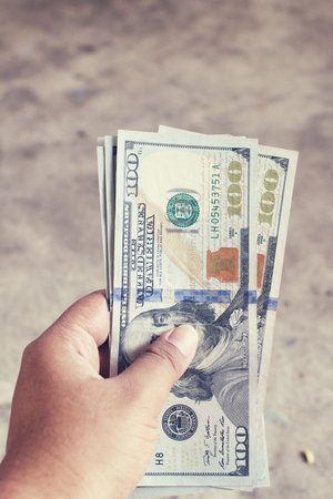 Dollars with hand