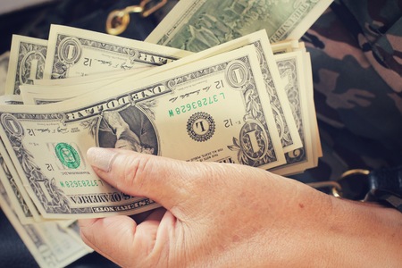 Dollars with handsの写真素材