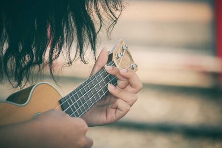 Woman playing ukuleleの写真素材