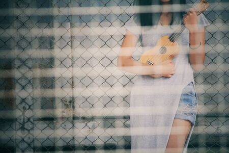 Blurred of woman with ukuleleの写真素材
