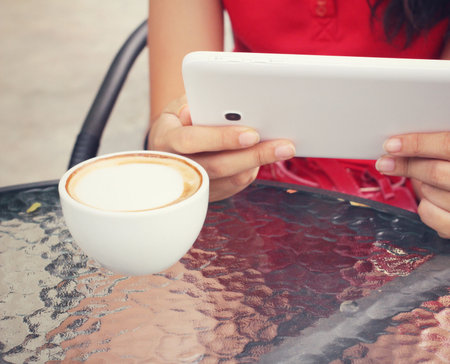 Latte coffee with tabletの写真素材