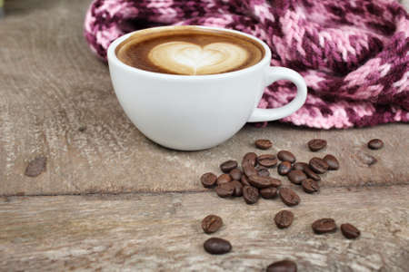 Vintage latte art coffee with scarfの写真素材