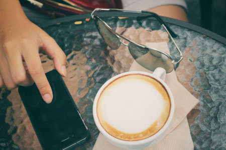 Latte coffee with smart phoneの写真素材
