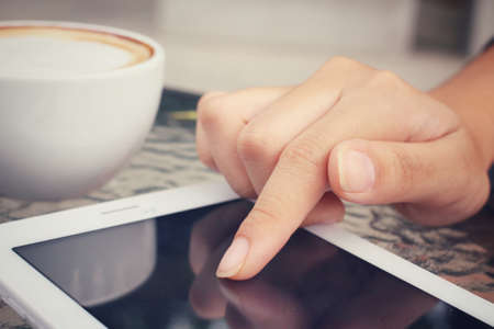 Latte coffee with tabletの写真素材