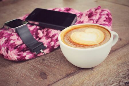 Latte coffee with smart phone and smart watchの写真素材