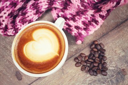 Vintage latte art coffee with scarfの写真素材