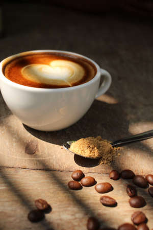 Vintage latte art coffee with shadowの写真素材