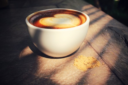 Vintage latte art coffee with shadowの写真素材