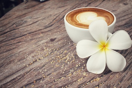 Vintage latte art coffee with flowerの写真素材