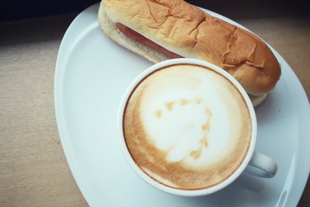 Vintage latte coffee with fast food hot dogの写真素材