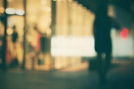 Blurred of people walking in city at nightの写真素材