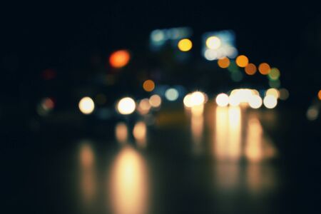 Blurred of car in city at nightの写真素材