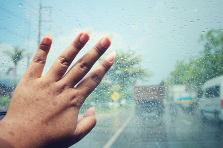 Water drop with road and handの写真素材