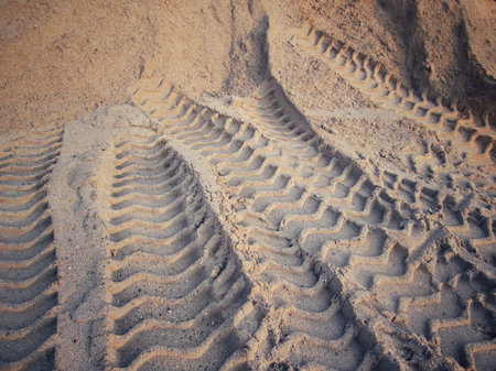 Wheel tracks on the soil.