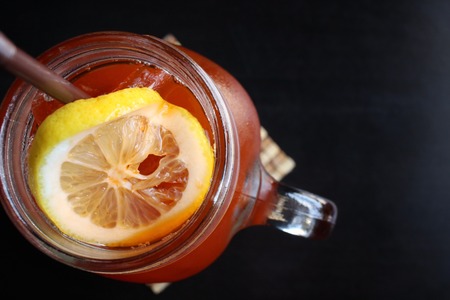 Ice tea with lemon on a jarの写真素材