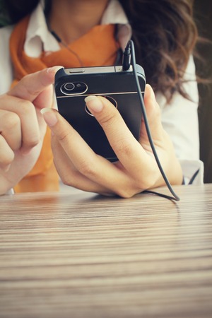 Businesswoman listening to music on earphone with smart phoneの写真素材