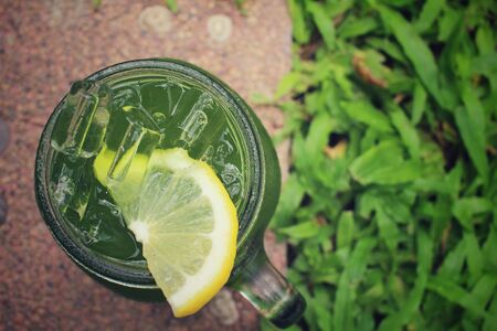 Ice green tea with lemon on a jarの写真素材