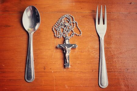 Spoon and fork with necklace crossの写真素材