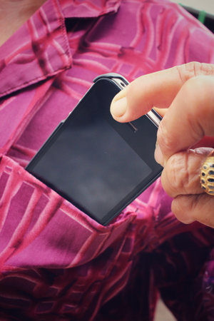 Senior with smart phone in pocket