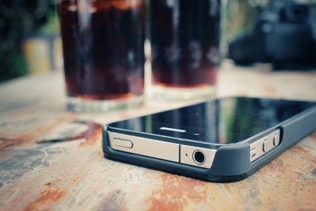 Smart phone with cola drinkの写真素材