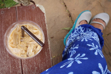Selfie of iced coffee with shoesの写真素材