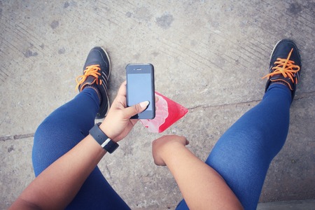 Woman using smart phone with strawberry drinkの写真素材