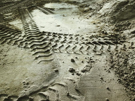 Wheel tracks on the soil.