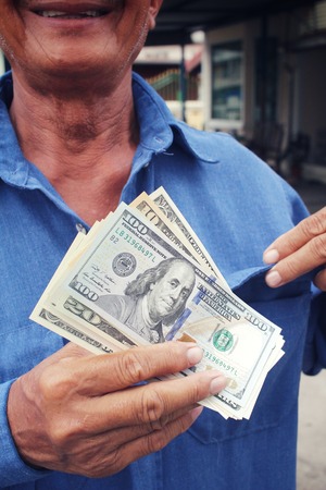 Senior man holding of dollarsの写真素材