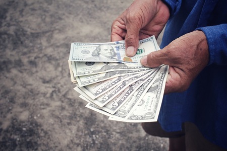 Senior man holding of dollarsの写真素材
